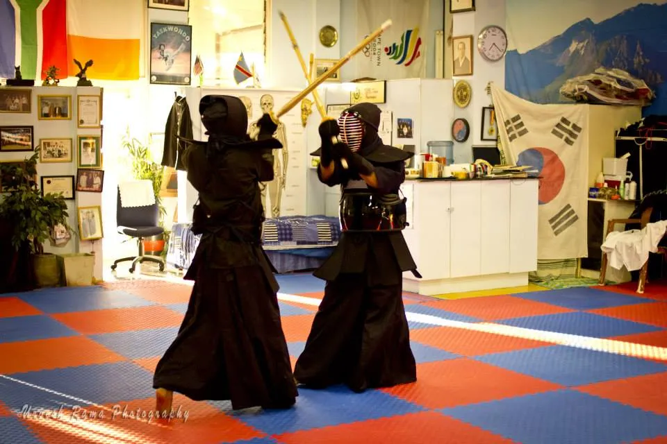 KJD students in traditional uniform practising with bamboo swords.