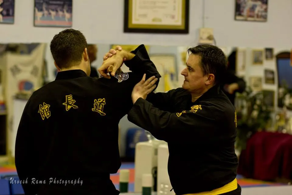 Two KJD students practising a knife defence technique.